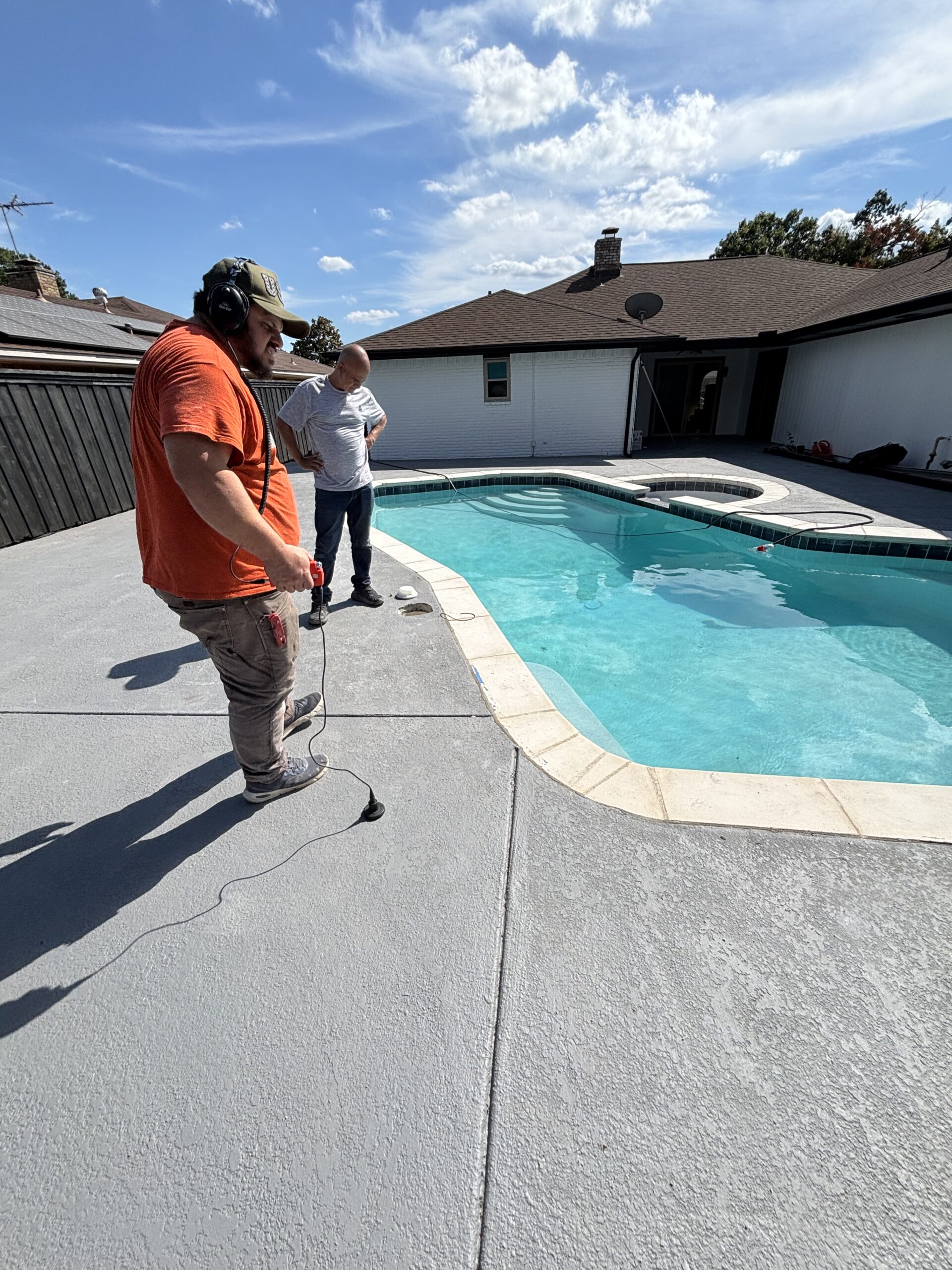 Technician comparing pool deck locations with electronic listening equipment