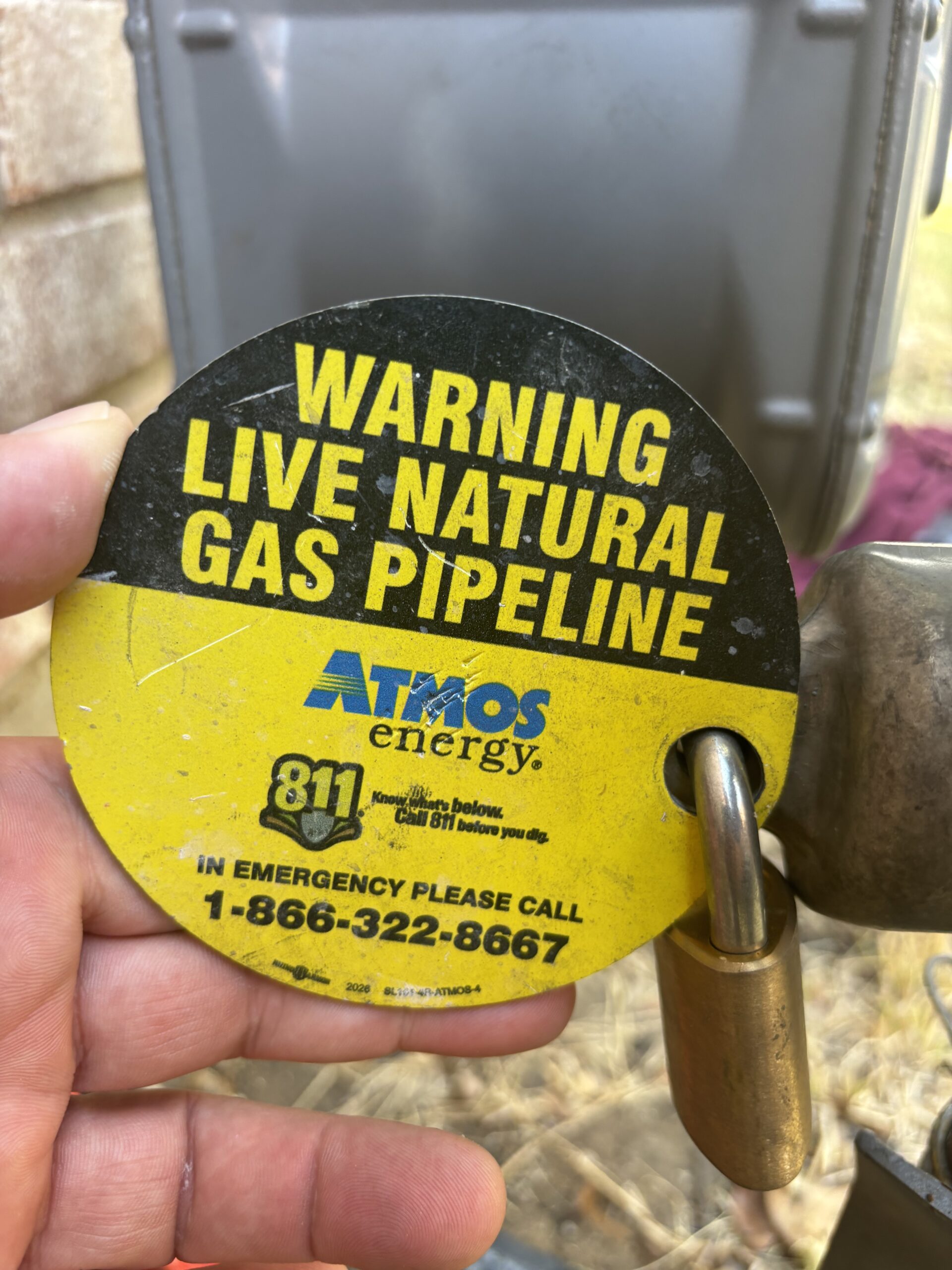 Gas service warning tag at a North Texas property requiring professional follow-up